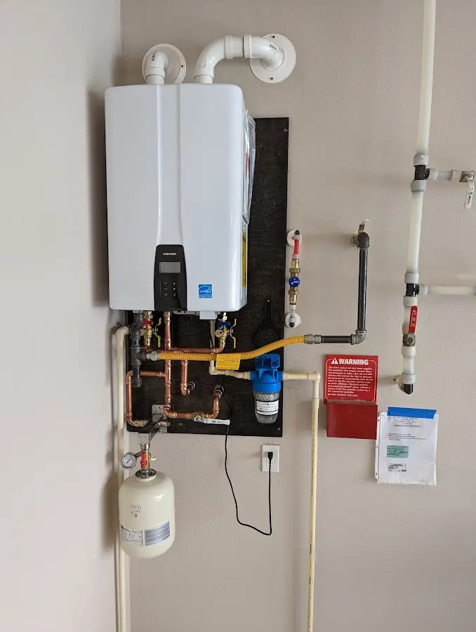 Professional plumber installing copper piping in a Rochester home